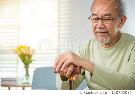 Close up hands of Asian Elderly hand holding handle of cane, senior disabled man holding walking stick, Old man sitting resting at home hold wooden walking cane, International Day for the Elderly Close up hands of Asian Elderly hand holding handle of cane, senior disabled man holding walking stick, Old man sitting resting at home hold wooden walking cane, International Day for the Elderly 110705085