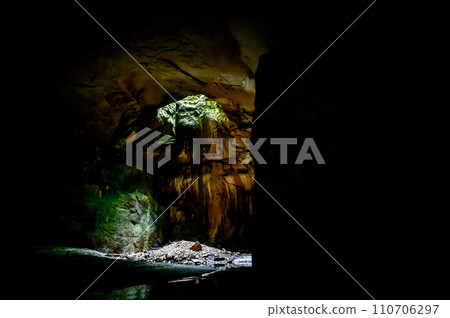 looking up towards a sink hole in an underground cave looking up towards a sink hole in an underground cave 110706297