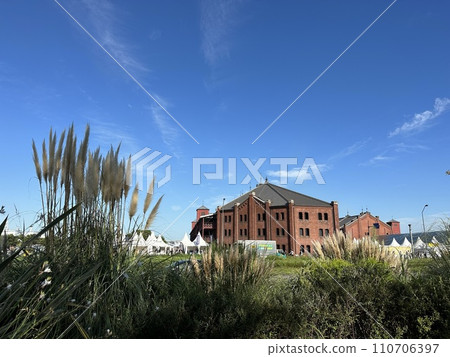 Red brick warehouse shining against the blue sky 110706397