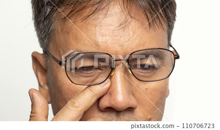 Senior man eyestrain after for long stretches at computer or digital screens. 110706723