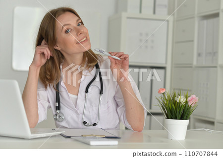 Beautiful girl doctor working at her laptop Beautiful girl doctor working at her laptop 110707844