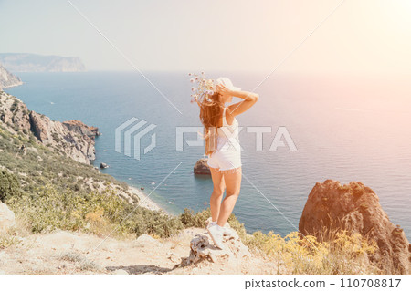 Woman summer travel sea. Happy tourist enjoy taking picture outdoors for memories. Woman traveler posing over sea bay surrounded by volcanic mountains, sharing travel adventure journey Woman summer travel sea. Happy tourist enjoy taking picture outdoors for memories. Woman traveler posing over sea bay surrounded by volcanic mountains, sharing travel adventure journey 110708817