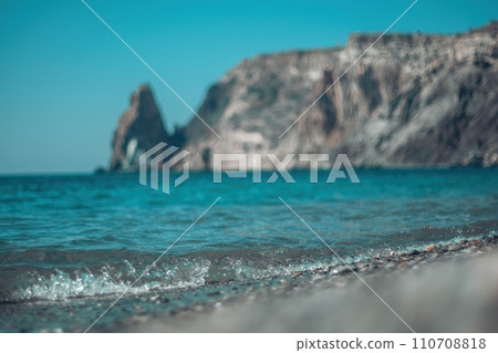 Abstract nature summer ocean sunset sea background. Small waves on water surface in motion blur with bokeh lights from sunrise. Holiday, vacation and recreational background concept Abstract nature summer ocean sunset sea background. Small waves on water surface in motion blur with bokeh lights from sunrise. Holiday, vacation and recreational background concept 110708818