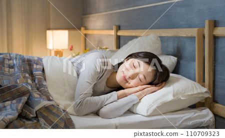Young woman sleeping in bed (AI generated image) Young woman sleeping in bed (AI generated image) 110709323