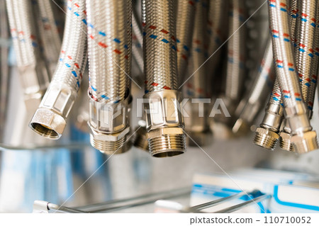 Metal plumbing thin pipes background texture. Lots of gray drain hoses Metal plumbing thin pipes background texture. Lots of gray drain hoses 110710052