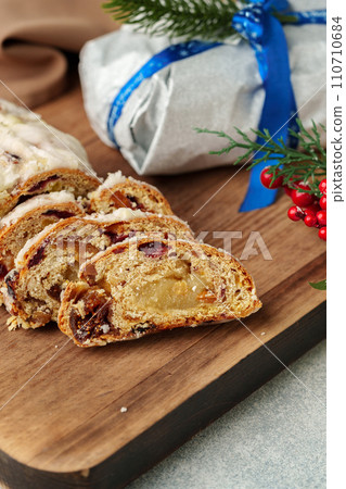 Christmas stollen on wooden cutting board close up 110710684