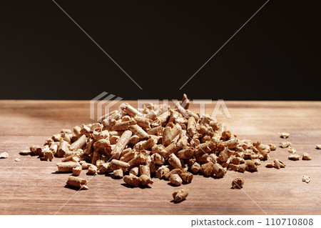 Heap of wooden pellets biofuel on wooden table 110710808