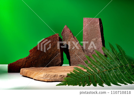 Stone display for product against green background Stone display for product against green background 110710818