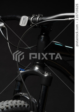 Close up of a bicycle against black background Close up of a bicycle against black background 110710826