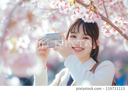High school student looking at smartphone under cherry tree "AI generated image" 110711113