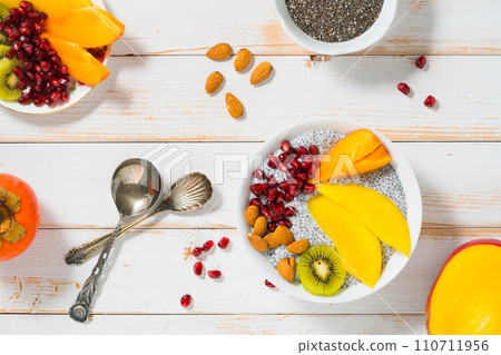 chia pudding with various fruits on white wooden background chia pudding with various fruits on white wooden background 110711956