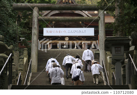 Kotohira Shrine, a pilgrim going up the four steps in front of the main shrine. Kotohira Shrine, a pilgrim going up the four steps in front of the main shrine. 110712080