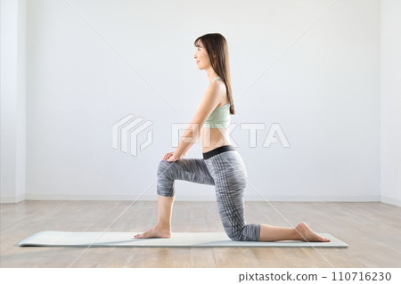 A woman stretching her lower body 110716230