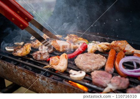 Delicious assorted meat with vegetables on charcoal grill. Rest, barbecue. 110716310