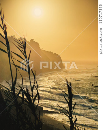cliff overlooking the sea at sunset 110717556