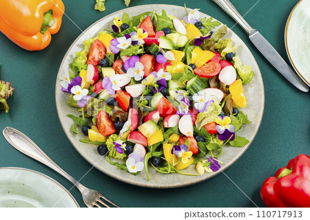 Vegetable salad decorated with flowers. 110717913