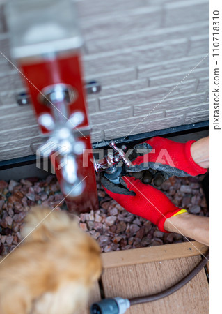 A man laying gravel, gardening, gardening 110718310