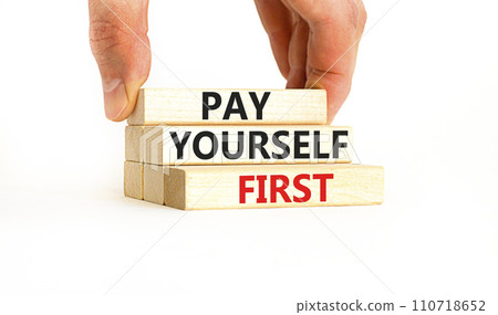 Pay yourself first symbol. Concept words Pay yourself first on beautiful wooden blocks. Beautiful white table white background. Businessman hand. Business and pay yourself first concept. Copy space. 110718652
