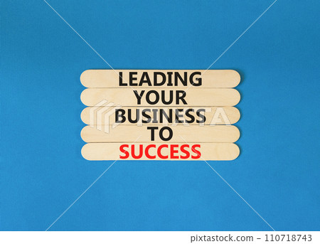 Leading your business to success symbol. Concept words Leading your business to success on wooden stick. Beautiful blue table blue background. Leading your business to success concept. Copy space. Leading your business to success symbol. Concept words Leading your business to success on wooden stick. Beautiful blue table blue background. Leading your business to success concept. Copy space. 110718743