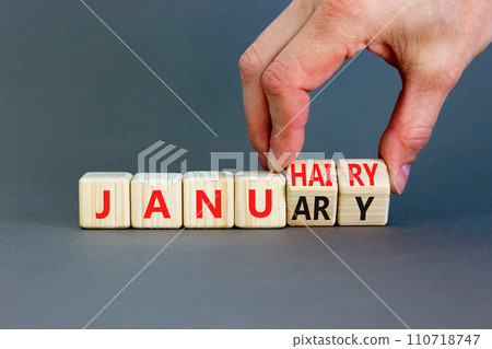 Januhairy or January symbol. Concept words Januhairy or January on beautiful wooden blocks. Beautiful grey table grey background. Man hand. Social issues Januhairy or January concept. Copy space. 110718747