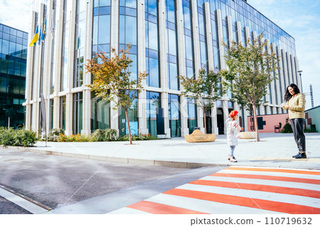 Caucasian mother and her child near crosswalk outdoors. Happy family moments concept. 110719632