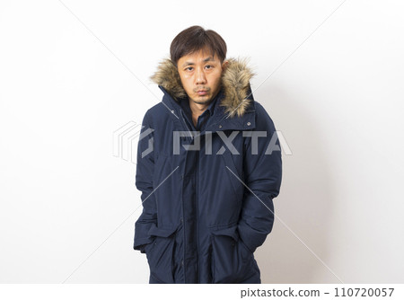 adult asian man in cold winter coat with scarf, hat and glove stand on white background. 110720057