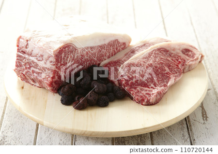 Raw dry aged wagyu beef on a wooden cutting board 110720144
