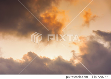 evening sky in orange glow. huge fluffy clouds. dramatic natural background in summer 110720236