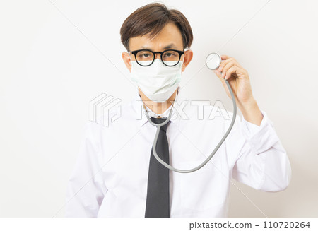 Handsome Asian man doctor with face mask and stethoscope on white background. Handsome Asian man doctor with face mask and stethoscope on white background. 110720264