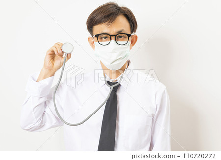 Handsome Asian man doctor with face mask and stethoscope on white background. Handsome Asian man doctor with face mask and stethoscope on white background. 110720272