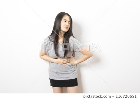 Young asian woman have stomach ache with uneasy face 110720651