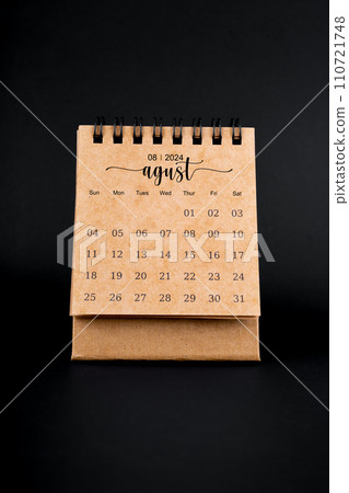 2024 August brown desk calendar on black. 2024 August brown desk calendar on black. 110721748