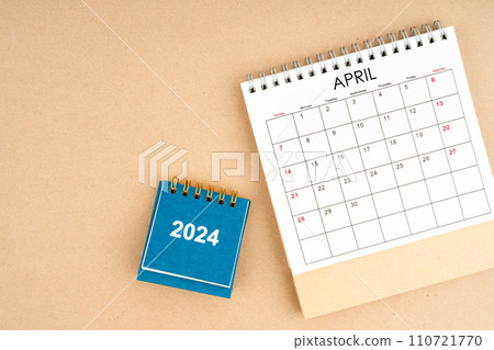 April 2024 desk calendar on brown color background, position with copy space. 110721770