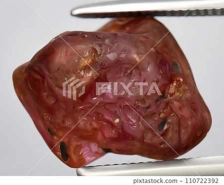 natural pink ruby rough gem on the background 110722392