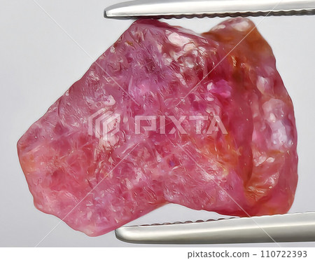 natural pink ruby rough gem on the background 110722393