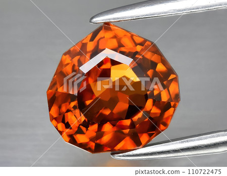natural orange zircon gem on the background natural orange zircon gem on the background 110722475