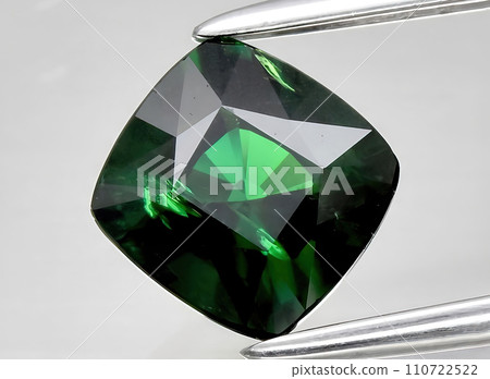 natural green tsavorite garnet gem on the background natural green tsavorite garnet gem on the background 110722522