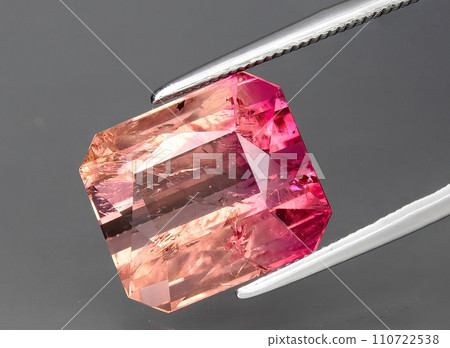 natural bi color tourmaline gem on the background natural bi color tourmaline gem on the background 110722538