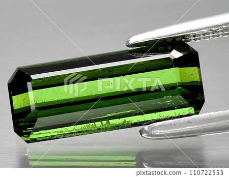 natural green tourmaline gem on the background natural green tourmaline gem on the background 110722553