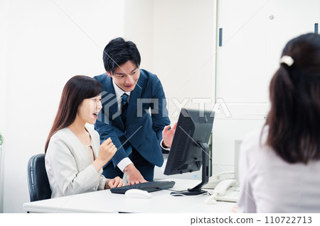 Young businessman reporting to his female boss 110722713