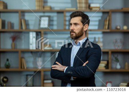 A seasoned professional stands with poise in his elegant office, exuding confidence as he ponders business strategies. 110723016