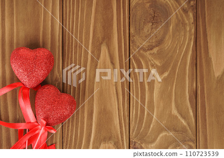 Red glittered hearts on brown wooden background with copy space Red glittered hearts on brown wooden background with copy space 110723539