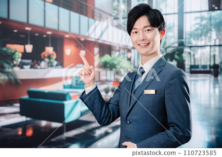 Hotel staff guiding customers 110723585
