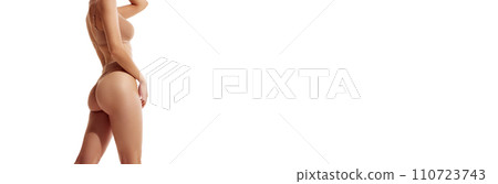 Banner. Cropped female body in beige lingerie against white studio background with negative space to insert text. 110723743