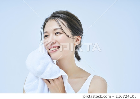 A woman wiping his face with a towel A woman wiping his face with a towel 110724103
