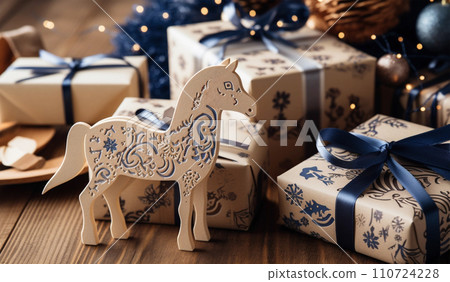 Gift boxes with bows and toy horse on vintage wooden background Gift boxes with bows and toy horse on vintage wooden background 110724228