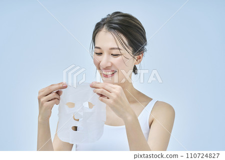 A woman doing skin care using a face pack A woman doing skin care using a face pack 110724827