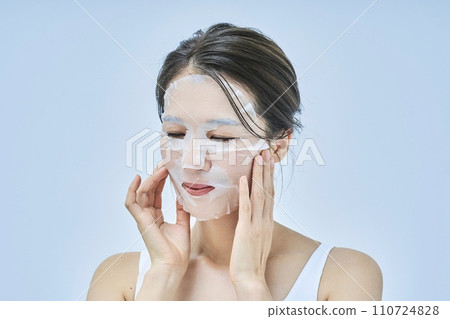 A woman doing skin care using a face pack A woman doing skin care using a face pack 110724828