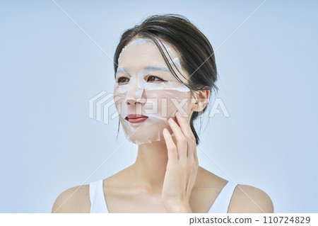 A woman doing skin care using a face pack 110724829