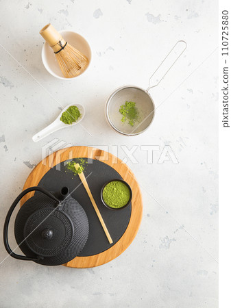 Japanese iron kettle with matcha green tea powder with whisk and spoon and bowl with sifter Japanese iron kettle with matcha green tea powder with whisk and spoon and bowl with sifter 110725880
